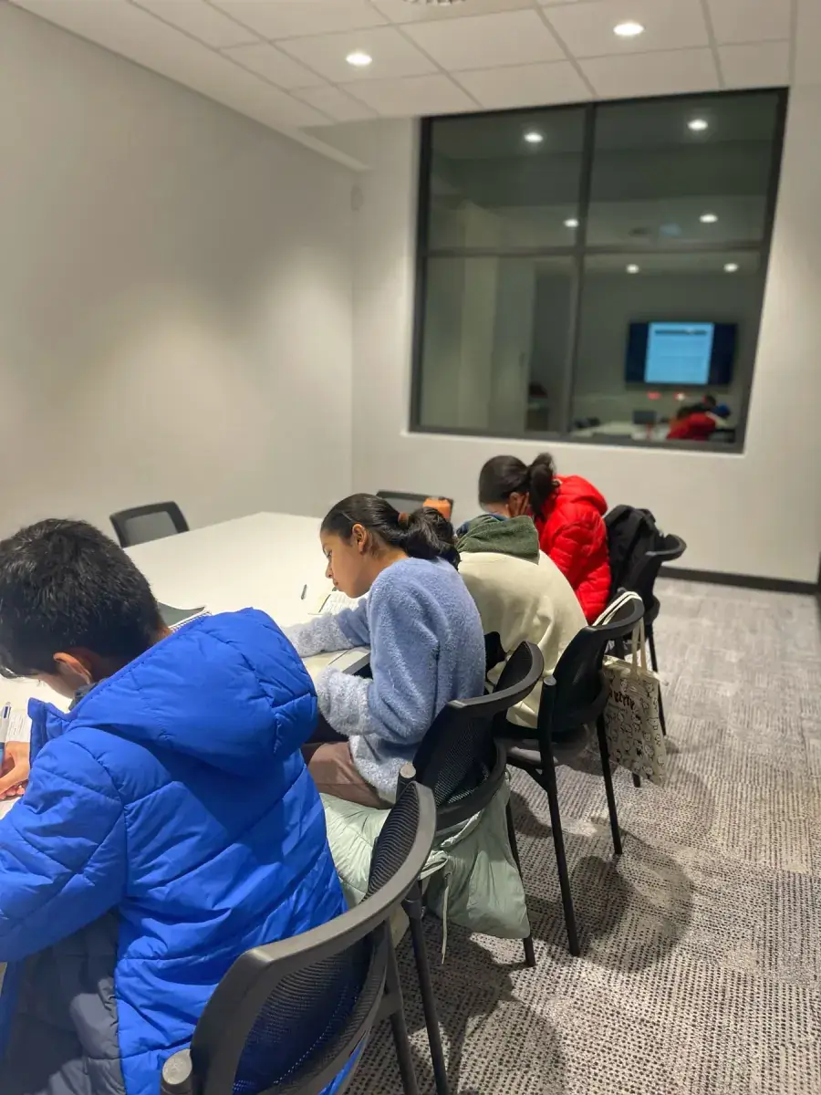 Students focused on workbook learning during a small-group session at AKademy38