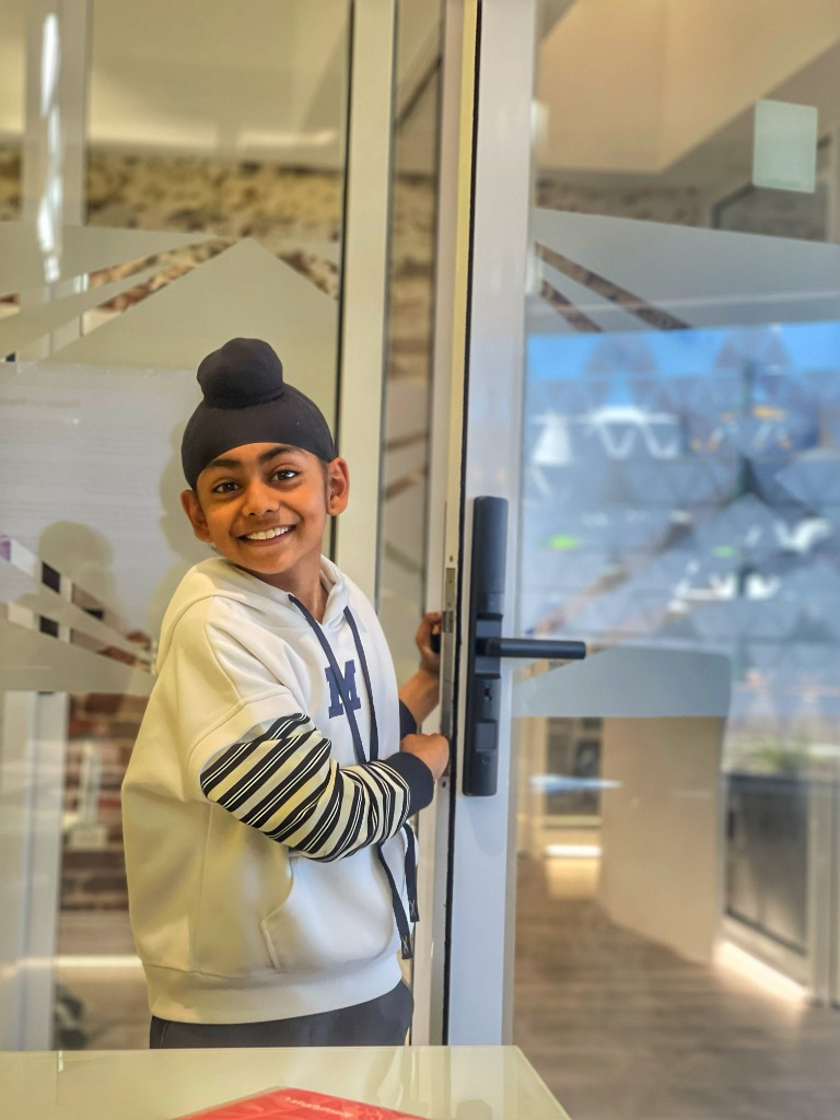 Smiling AKademy38 student welcoming everyone at the studio entrance